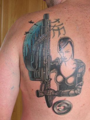 Girl With Gun Tat On Back